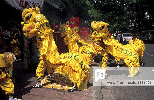Dragon dance performed as part of the grand opening for a shop in Ho Chi Minh City  Vietnam  Asia