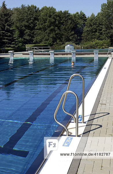 Lonely swimmer in an outdoor swimming pool