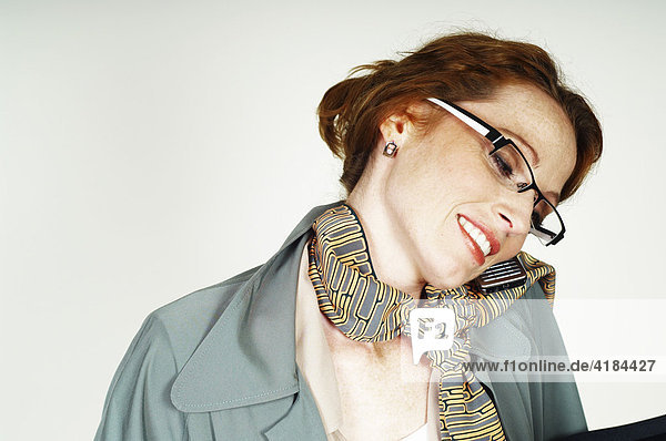 Businesswoman wearing glasses making a call with a mobile phone (cellphone)