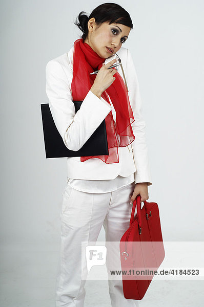 Young woman with red bag making a call with her mobile phone