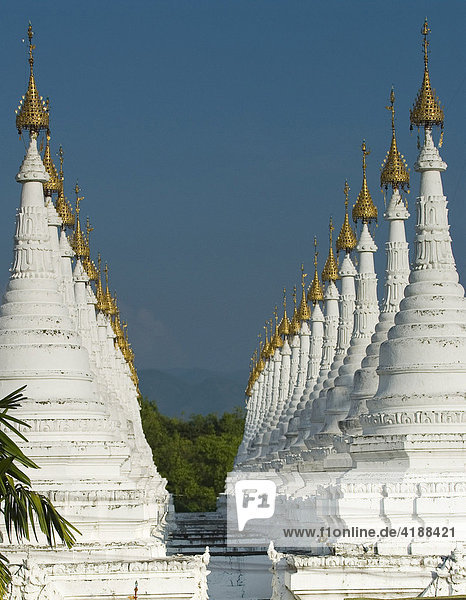 Lots of golden-tipped white stupas in two rows  Mandalay  Myanmar (Burma)  Southeast Asia