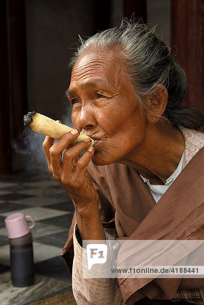 Old woman  smoking a cheroot  Burmese  Bagan  Burma  Myanmar  Southeast Asia