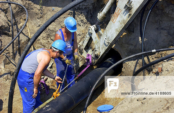 Mechanics replacing a pipe in a burrow