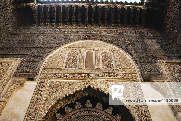 Schnitzereien in Stein und Zedernholz an der Fassade der Medersa Es Sahrij Fez Morocco