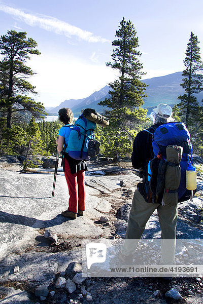 Hikers enjoying a view of Lake Lindeman  Chilkoot Trail  British Columbia  Canada