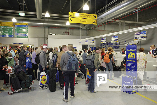 Passengers waiting at the check in on the airport Frankfurt-Hahn  Rhineland-Palatinate  Germany  Europe
