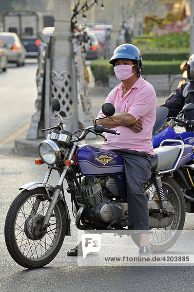 Motorcyclist wearing surgical mask in Koh Chang  Thailand  Southeast Asia  Asia
