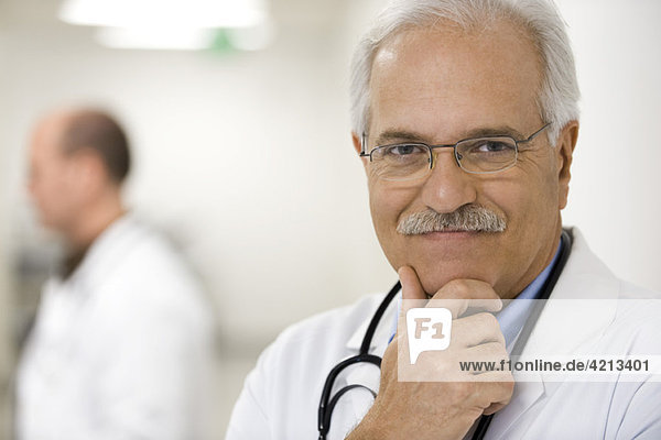 Doctor with hand under chin  portrait