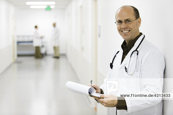 Doctor leaning against wall  portrait