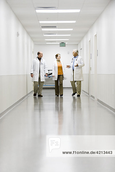 Doctors walking down hospital corridor