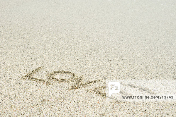 'The word ''love'' written in sand at the beach'