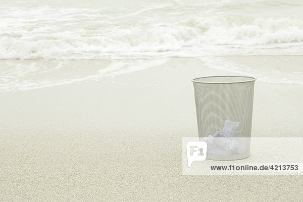 Wastepaper basket on beach