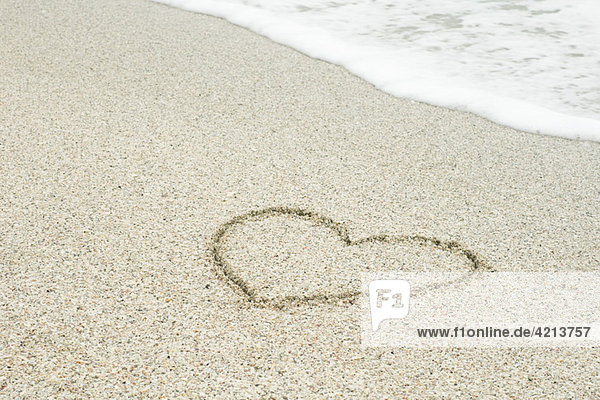 Heart drawn in sand at the beach