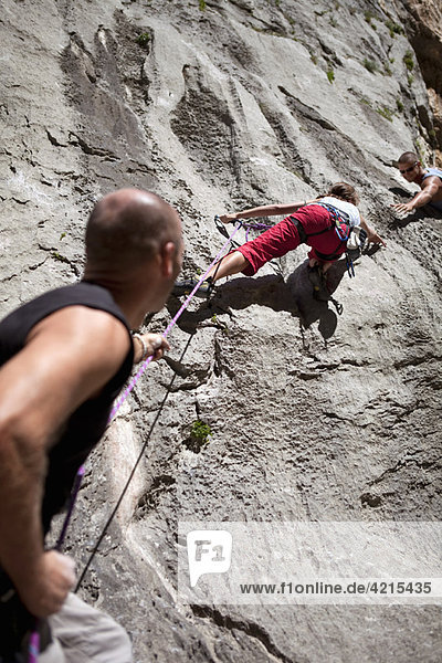 Rock climber securing partner