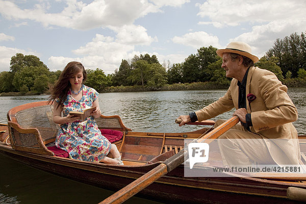 Father and daughter on a vintage boat