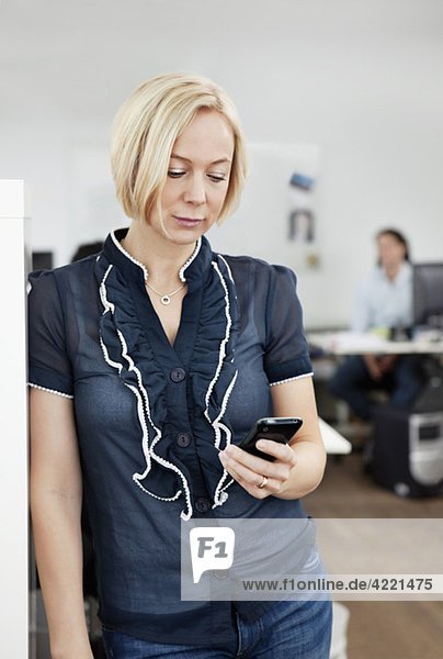 Businesswoman watching cellphone