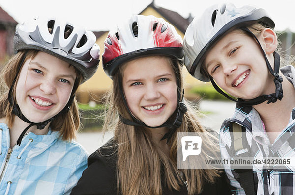 Three girls with bikehelmet