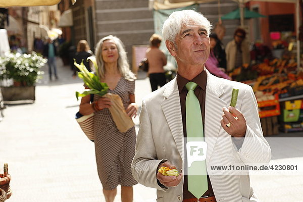 Senior couple strolling through town  Italy  Rapallo