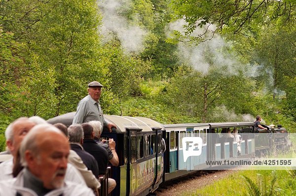 A steam train with people on the Ravenglass and Eskdale narrow gauge railway in Cumbria   England   Great britain   Uk