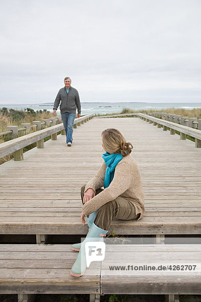 Woman and man on coastal walkway