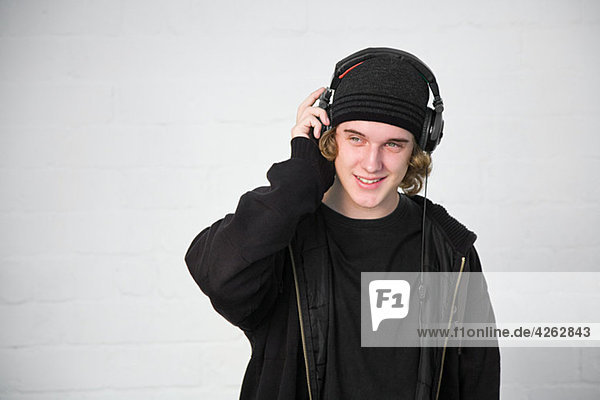 Portrait of teenage boy listening to music on headphones