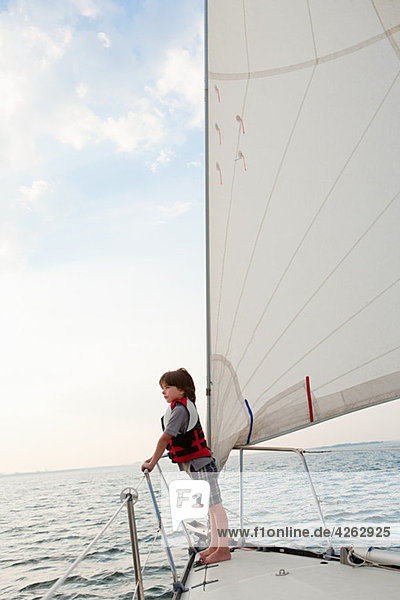 Young boy on board yacht  looking at view