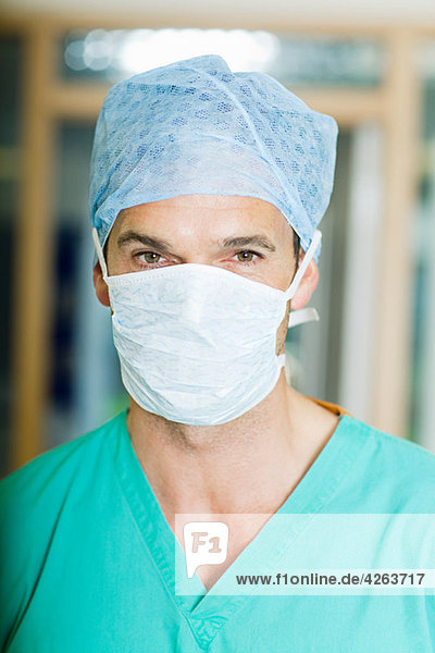 Male surgeon wearing mask and cap