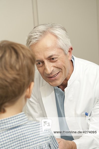 Doctor smiling at boy