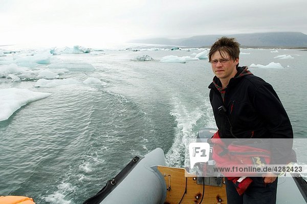 Iceland  Jokulsarlon glacier  icebergs floating on water  amphibian boat sight seeing trip.