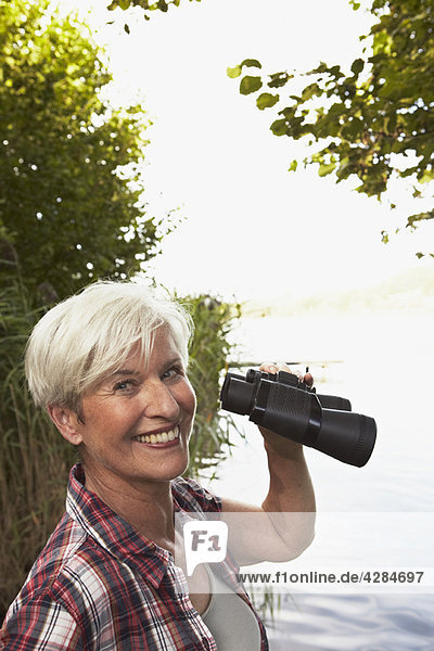 Senior woman holding binoculars