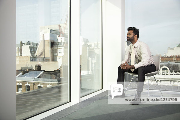 Businessman looking out of office window