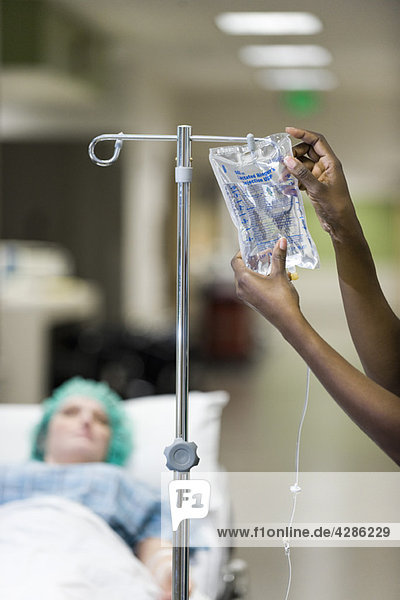 Healthcare worker preparing patient's IV drip