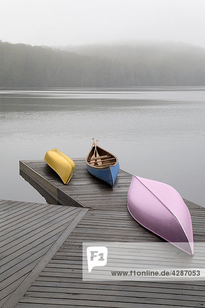 Colourful canoes on dock  Algonquin Park  Ontario