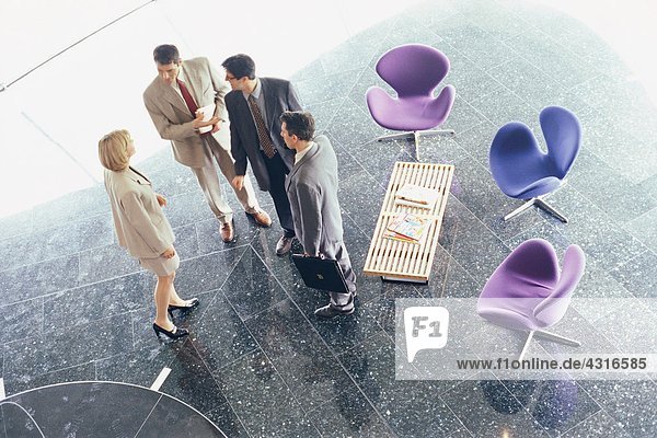Business associates standing in lobby  high angle view