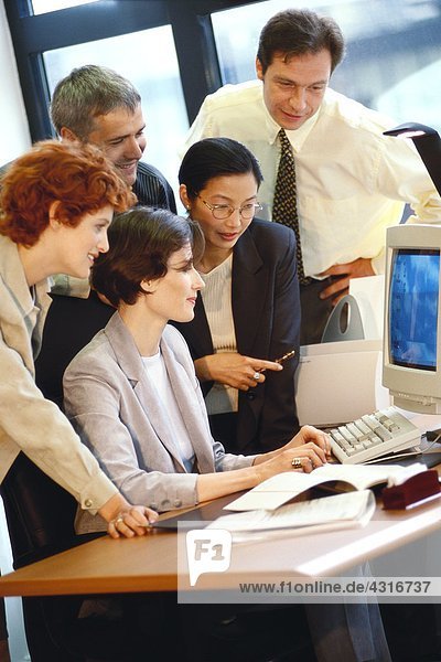 Group of businesspeople working together at desk