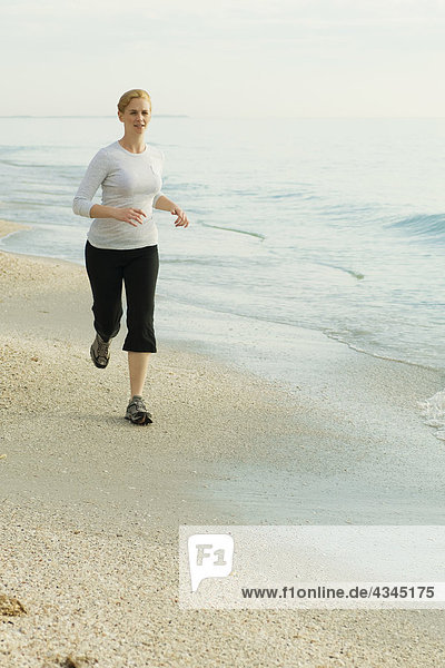 Woman running at the beach