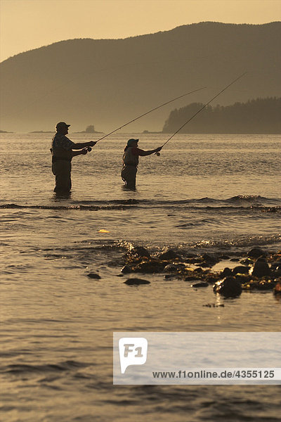 Couple Flyfishing Shoreline of Sitka Sound Near Harbor Point in Southeast Alaska