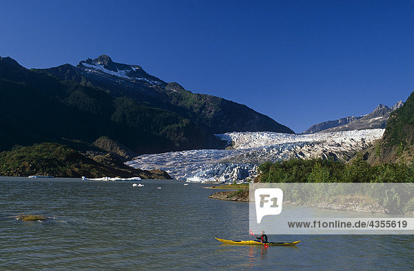Person kayaking on Mendenhall Lake w/glacier Coast Mtns Tongass Nat Forest Southeast AK Summer