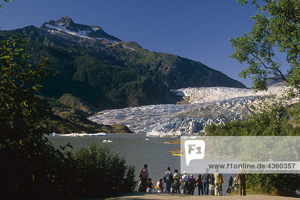 Visitors viewing Mendenhall Glacier from shoreline of Lake Southeast Alaska Summer Tongass Nat Forest
