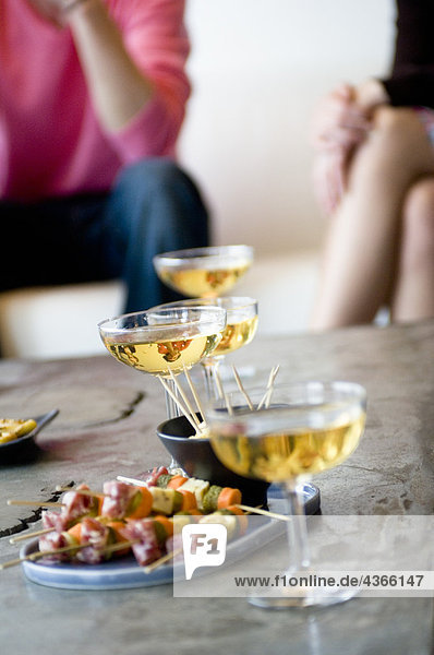 Close-up of glasses of champagne and cocktail snacks