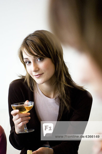 Young woman holding glass of champagne