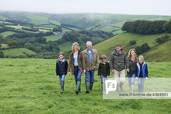 Generational family walking in fields