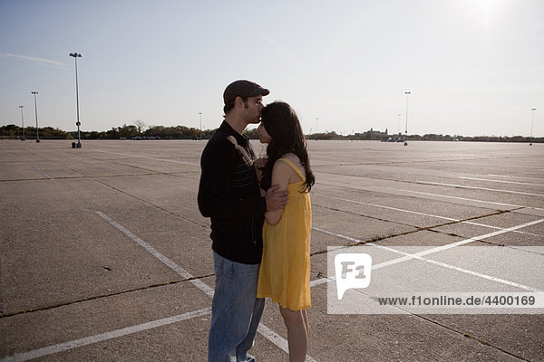 Couple embracing in the parking lot