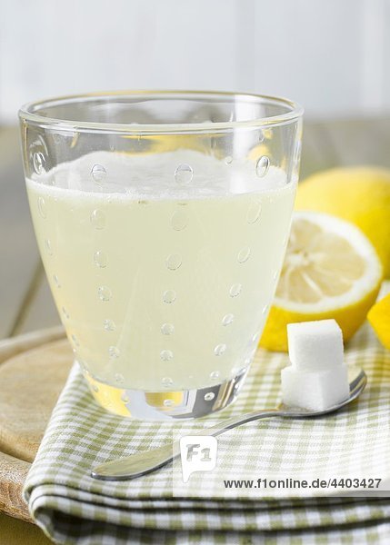 Hot lemon with sugar cubes  lemons in background
