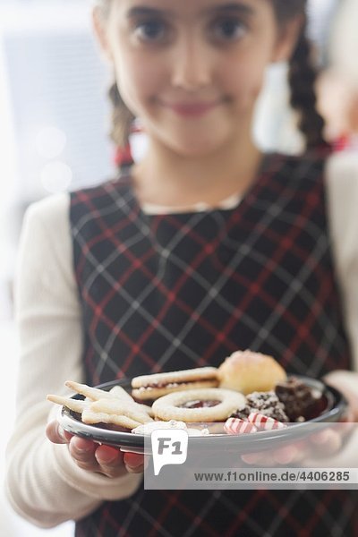 Girl holding plate of biscuits