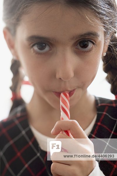 Girl eating candy stick