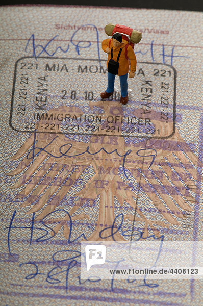 Figurine of man standing on passport