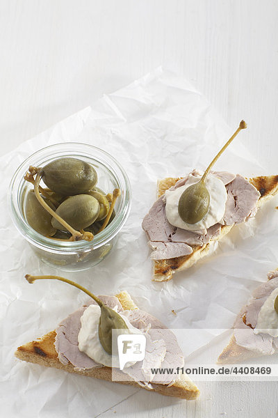'Vitello Tonato'' sandwich on white background  close-up'