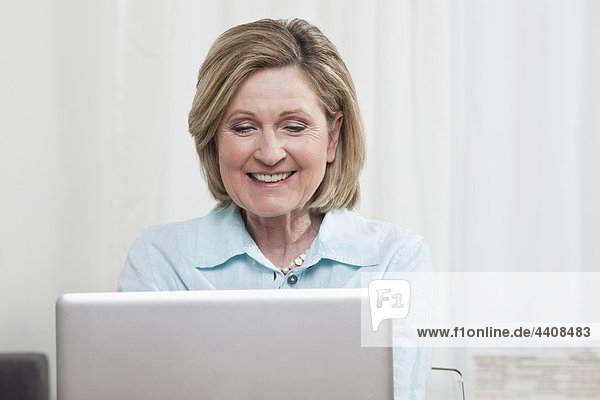 Woman using laptop  smiling