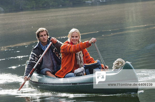 Austria  Obertauern  Young couple kayaking in lake